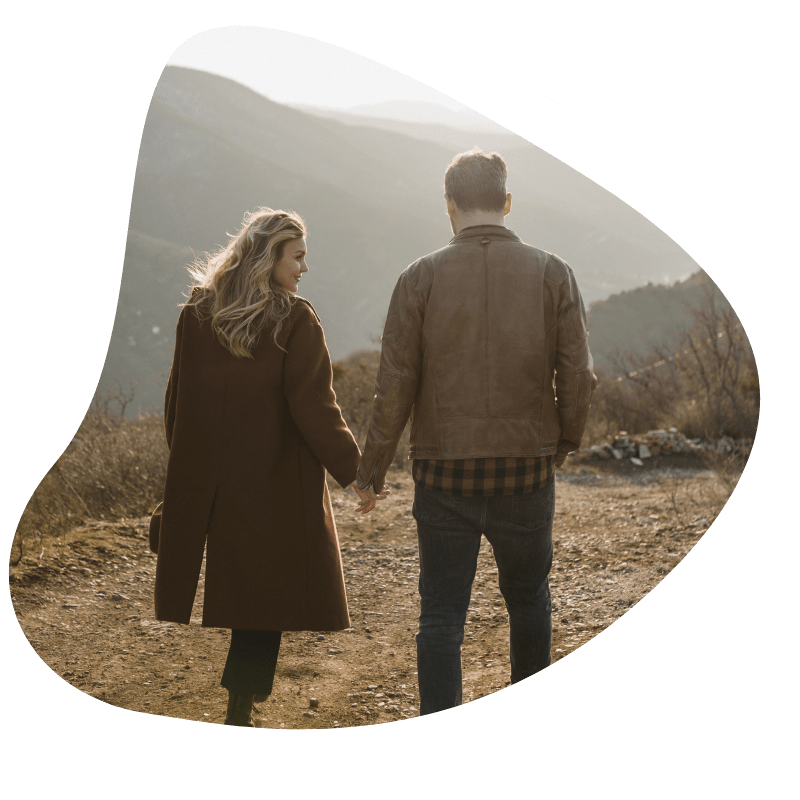 Couple holding hands in field