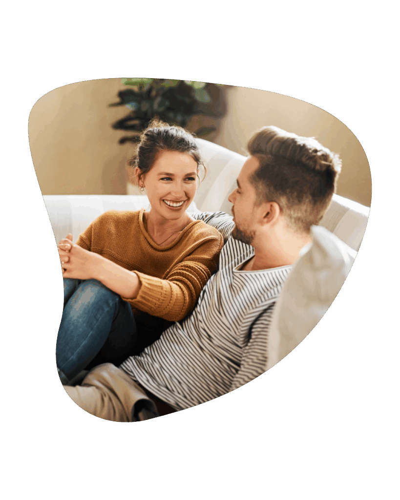 Happy smiling couple on light colored couch