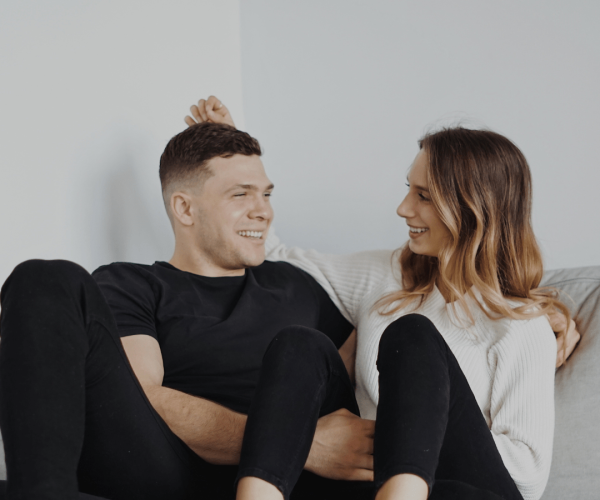 Happy relaxed couple on cushy sofa