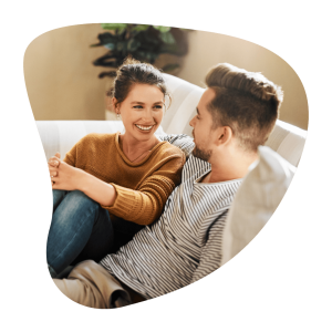 Happy smiling couple on light colored couch